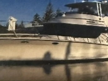 White 44ft motor craft docked in a marina