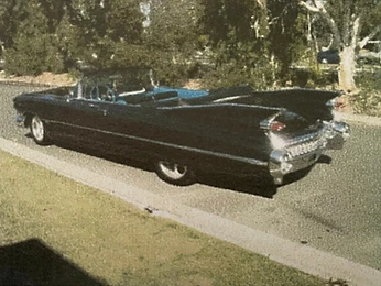 Vintage black American convertible with tail fins and blue interior