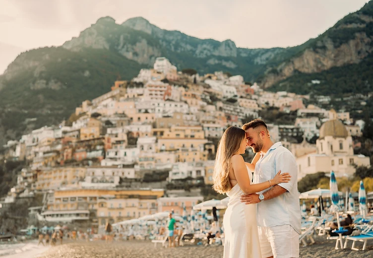 A couple embracing on the beach in Positano