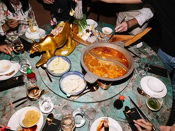 Hot pot tafel met gouden stier en kruidige bouillon