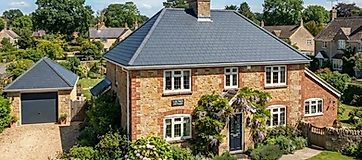 Wide exterior view of a house with a brand new tiled roof