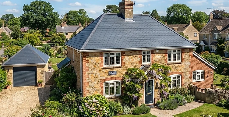 Wide exterior view of a house with a brand new tiled roof