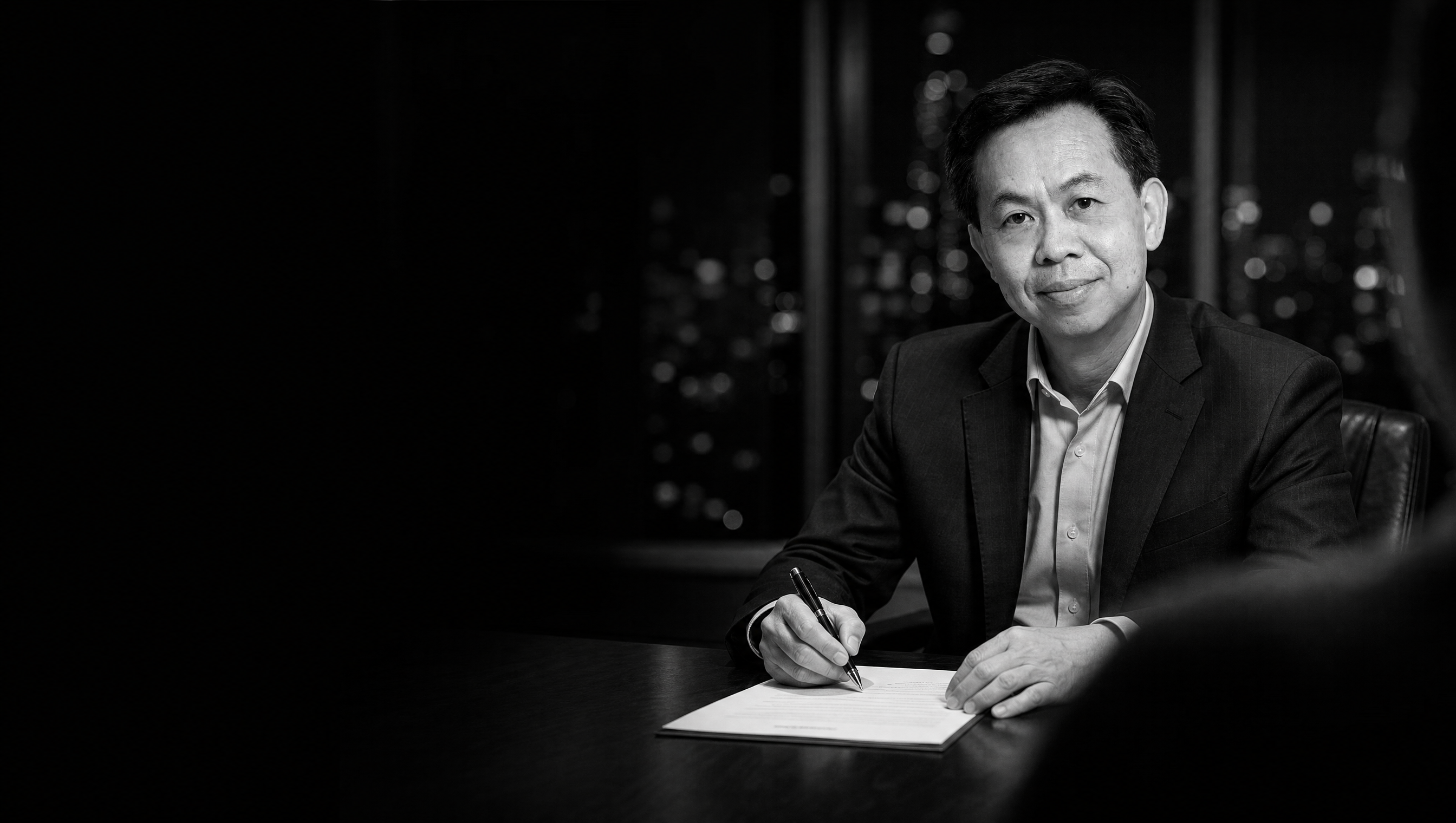 Portrait of Michael Honsue Cho seated at a desk, inventor and biotechnology founder