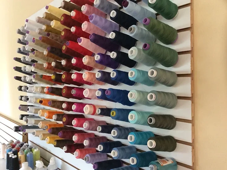 Wall of colorful sewing thread spools at Nick's Alterations