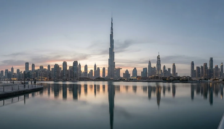 Illustrative Dubai waterfront skyline at sunset