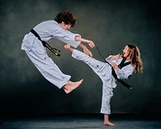 Taekwondo athletes sparring mid-air in the studio
