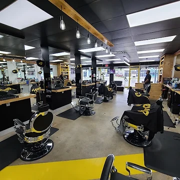 Rows of barber stations along the walls of Seven18 Barber Lounge