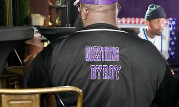 Cast member wearing Questions By Roy jersey