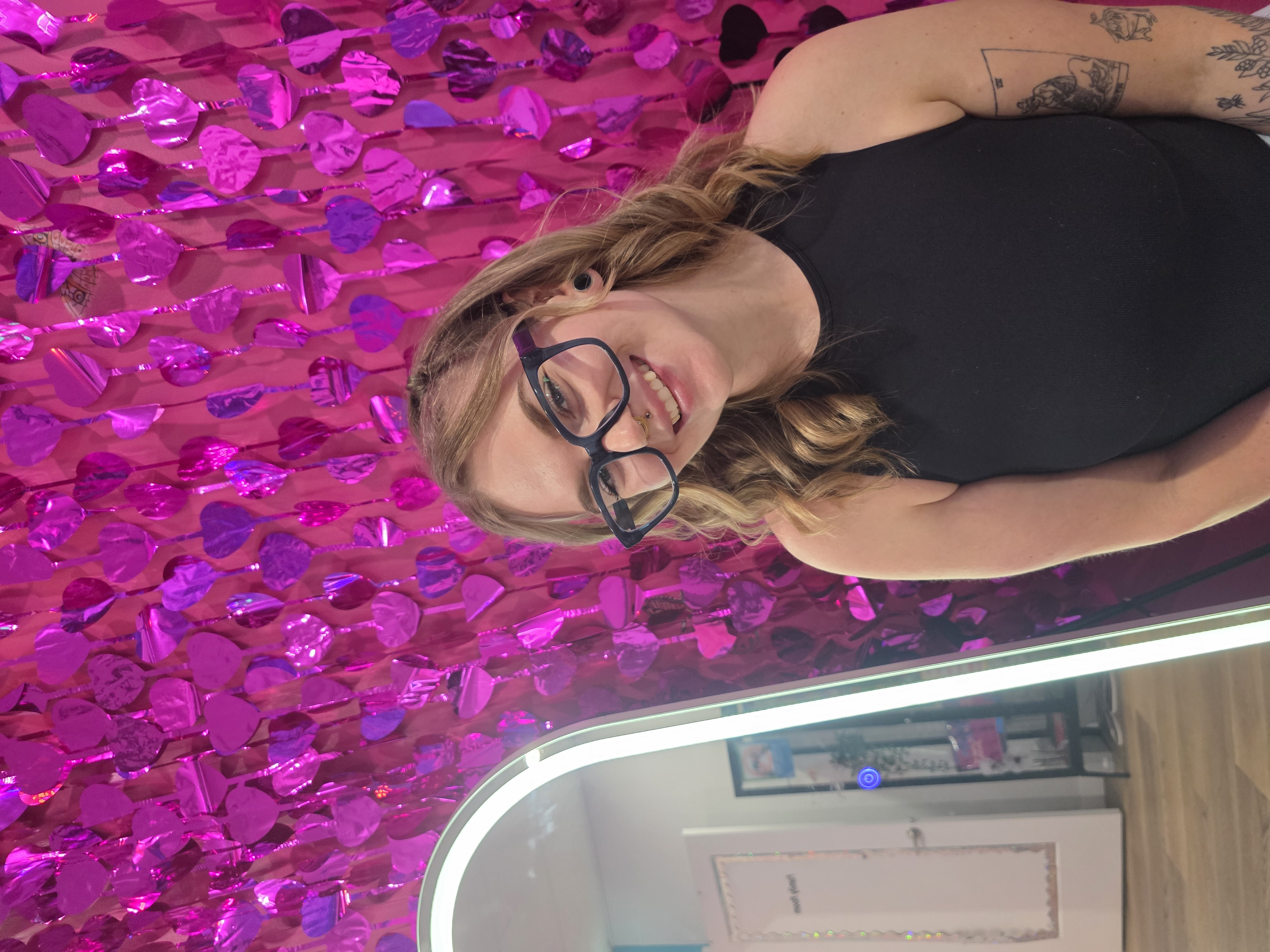 Iliana Kennedy, kids ear piercing specialist, smiling in the studio