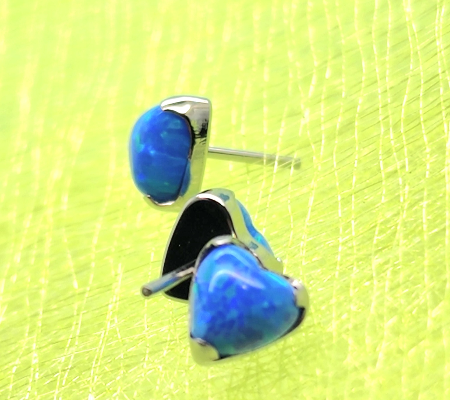 Heart shaped stud earrings with blue opal gems, hand finished body jewelry made in Calgary