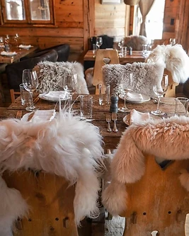 A long table set for dinner inside a mountain lodge