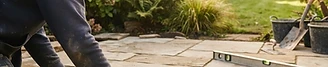 A landscaper laying a stone patio