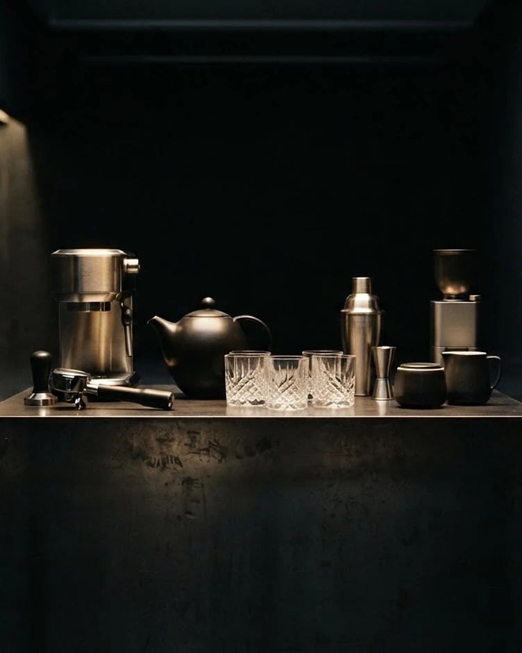Premium hospitality equipment arranged in a dark gallery setting