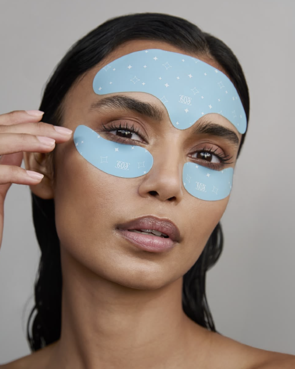 Close-up of blue hydrogel skincare patches on the forehead and under the eyes