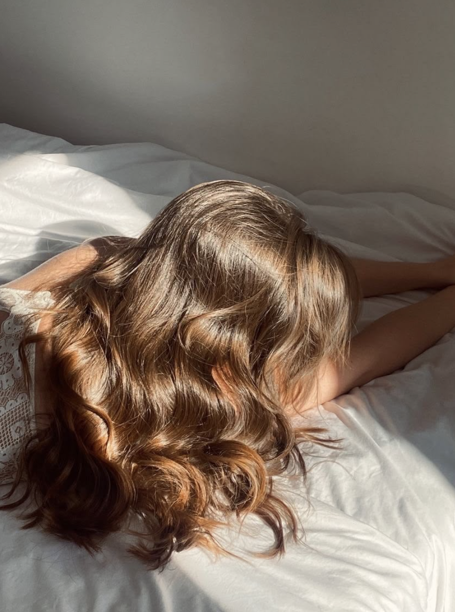 Soft, shiny waves on silk sheets