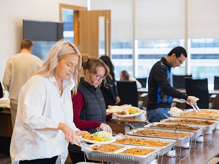 Fiesta catering buffet — guests serving from a taco bar