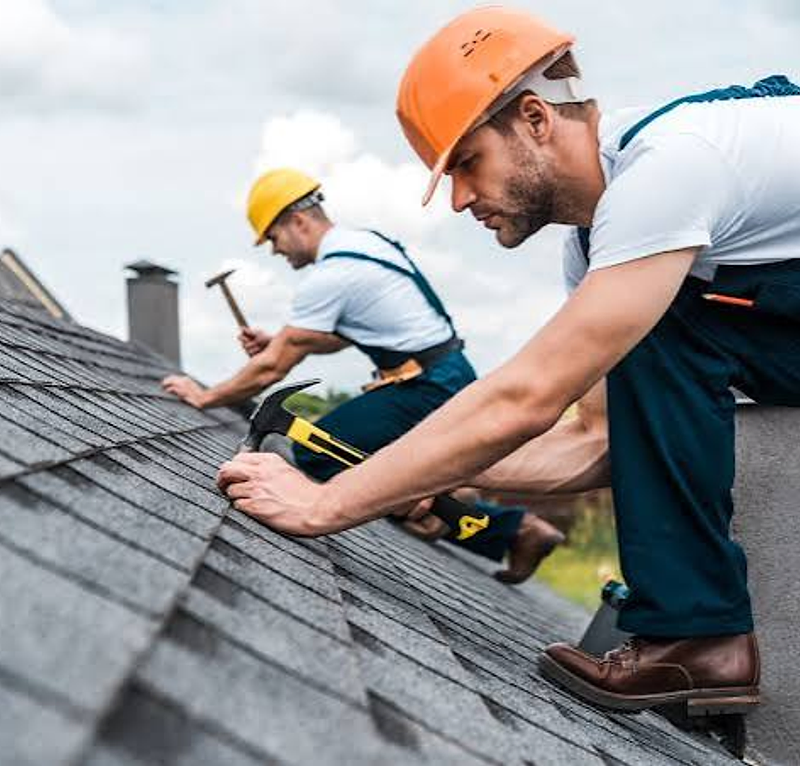 Roofing contractors installing shingles