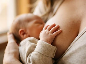 A baby's hand during breastfeeding