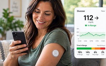 Woman viewing her glucose monitoring app on a phone