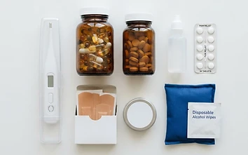 Assorted over-the-counter health products arranged on a white background