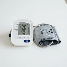 Digital blood pressure cuff displaying a reading