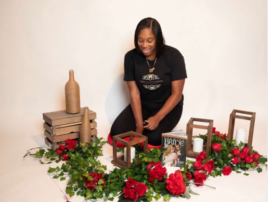 NiKeshia, Owner & Designer of Take Flight Events, styling an event setup