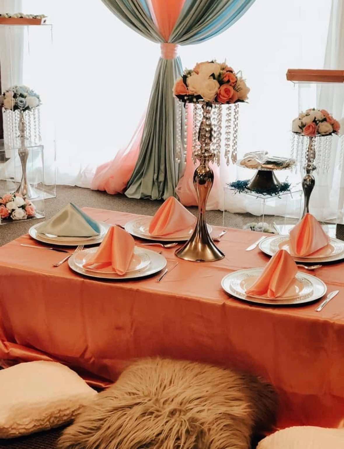 Peach and coral styled table with crystal stands and floral arrangements