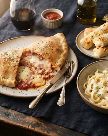 Calzone, pasta y palitroques con queso de El Puerto San Jorge