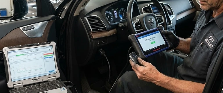 Locksmith programming a car key fob for a driver in Centennial, CO