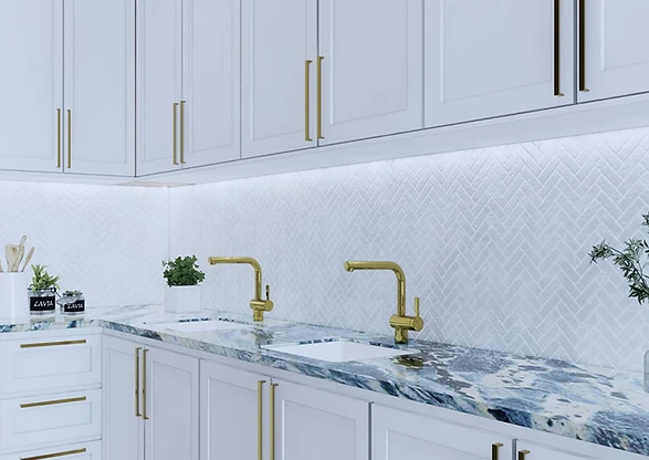 High-end white kitchen with marble counters and brass fixtures