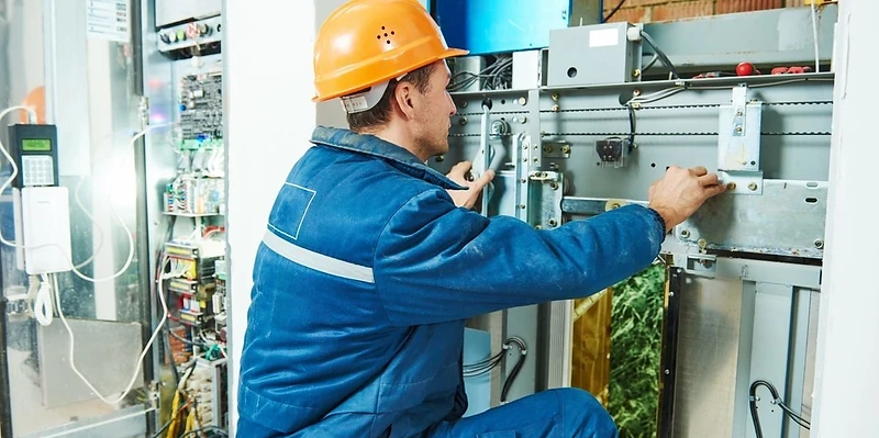 Triennium technician performing elevator maintenance