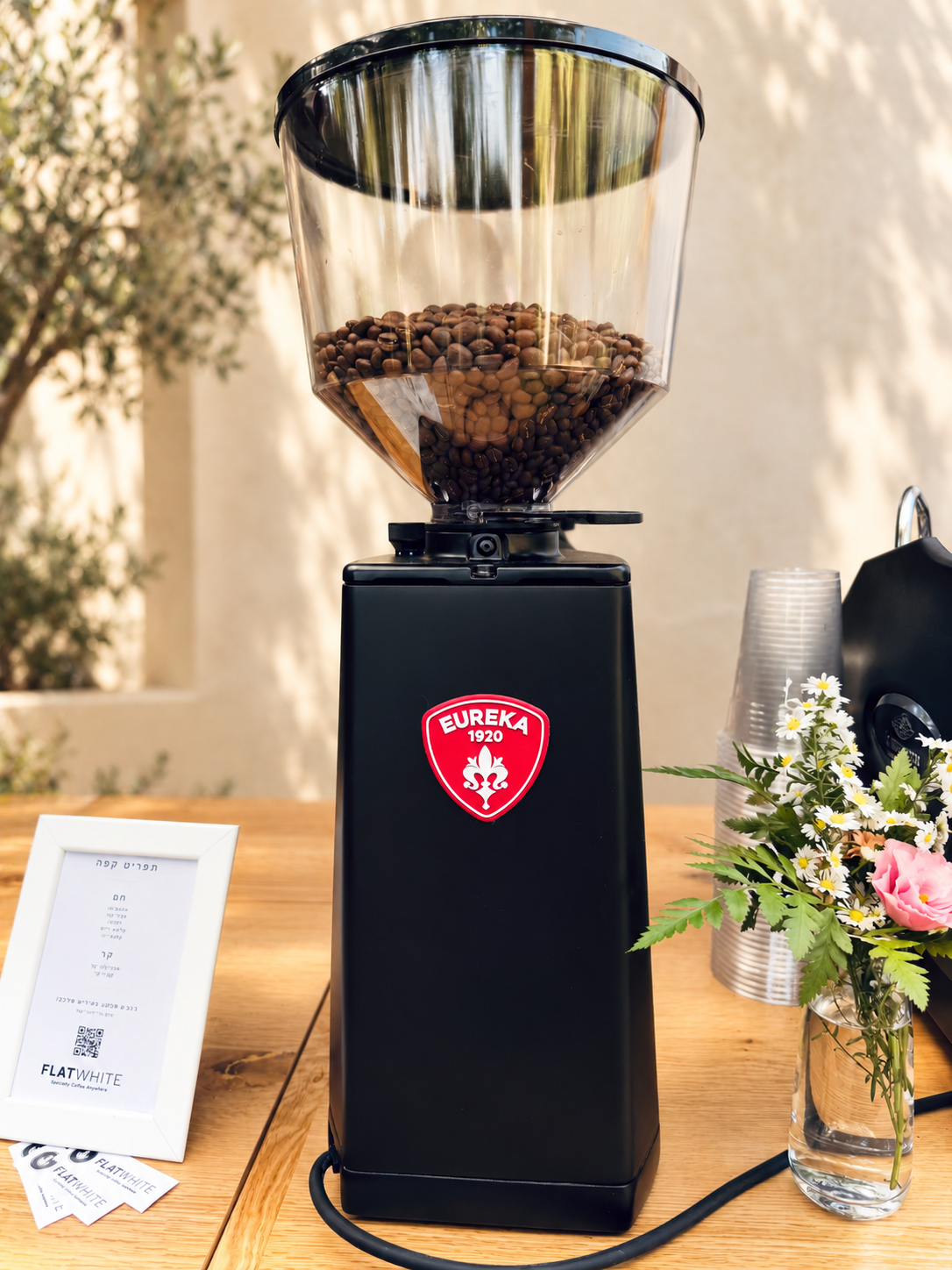 Eureka Atom 75 GBW coffee grinder with bean hopper and red Eureka badge