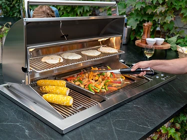Fire Magic E540d stainless steel outdoor grill built into a stone countertop