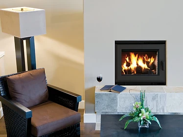 Astria Ladera modern black fireplace insert in a light beige living room wall