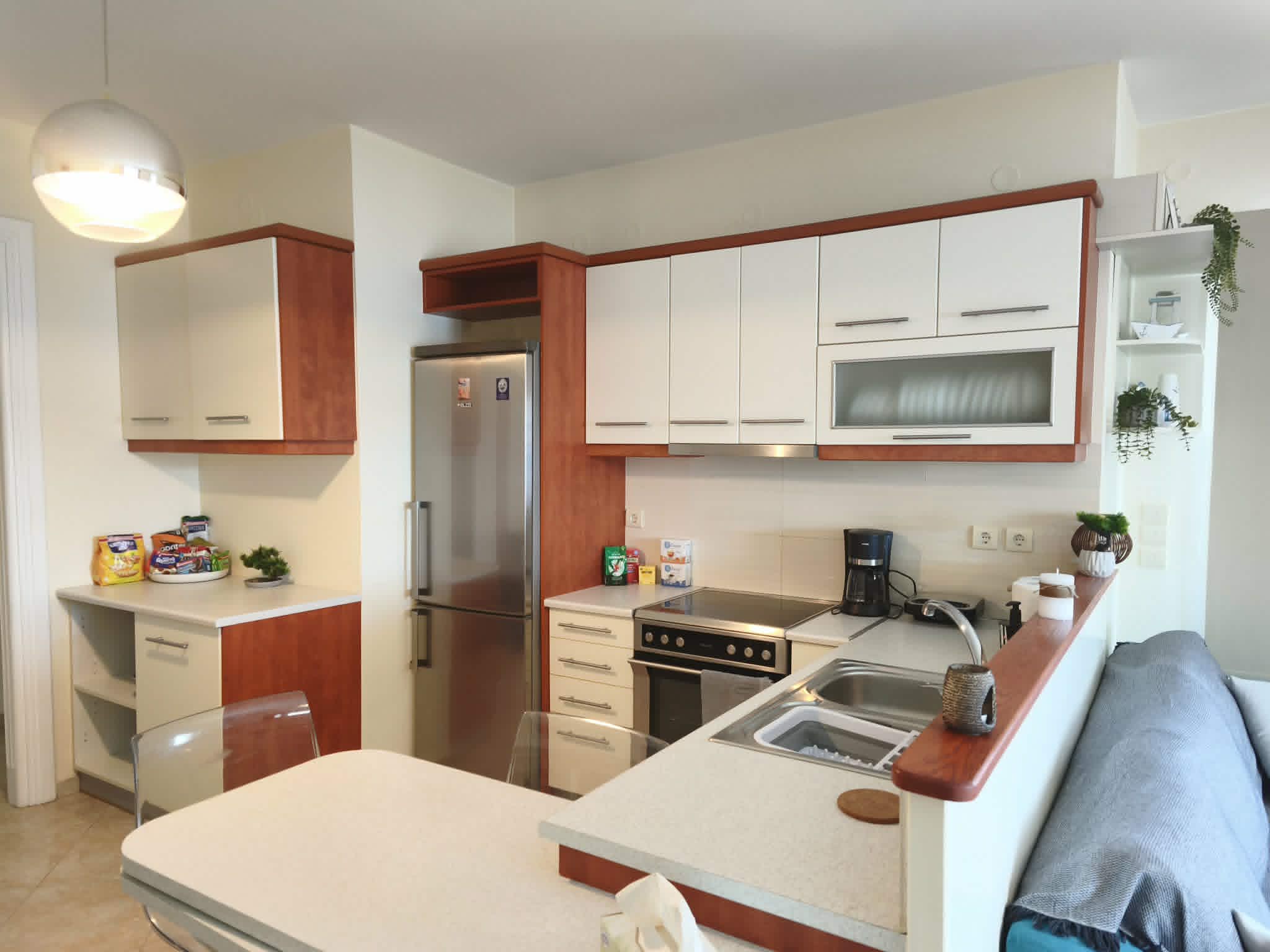 Kitchen with cooktop, oven & refrigerator