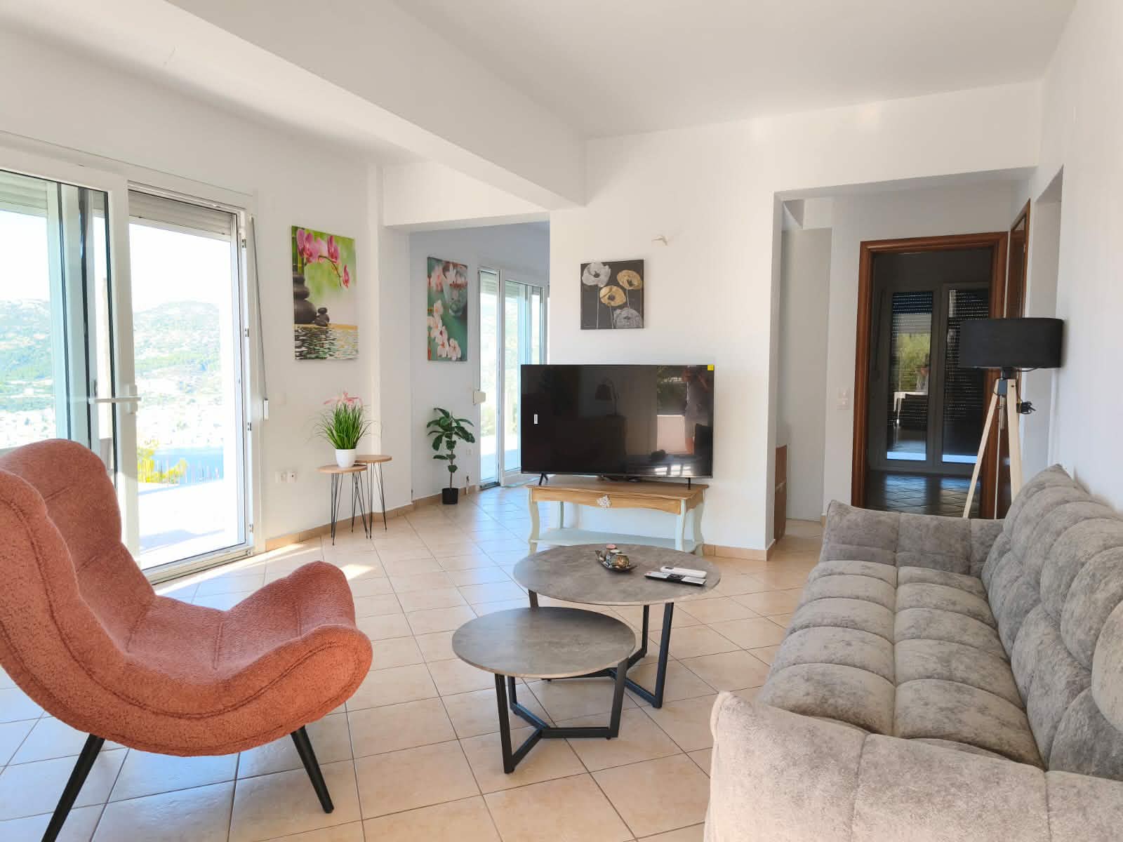 Living room with sofa, armchair & sea-view balcony