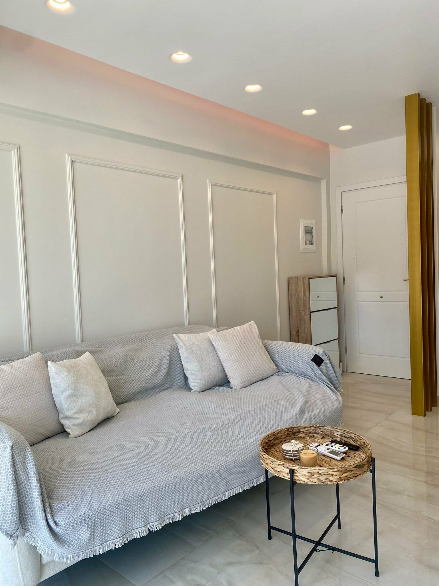 Living area with storage cabinet & gold accent pillar