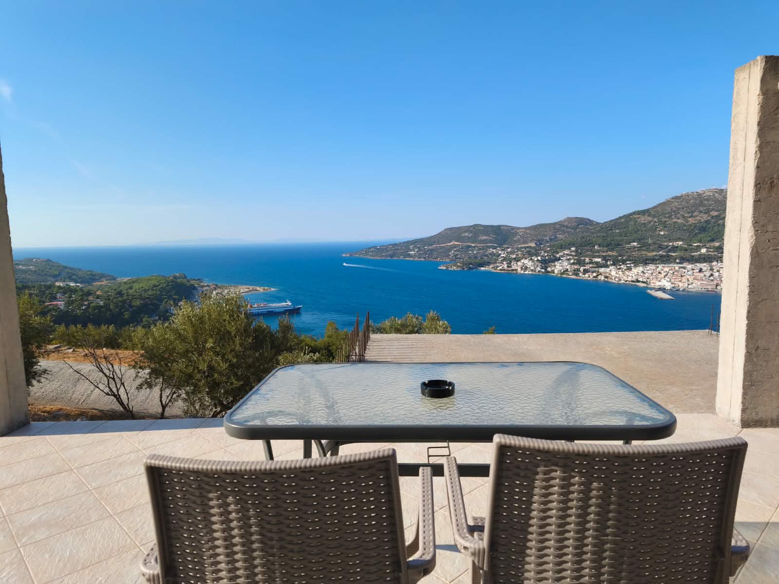 Terrace with dining table & panoramic sea view