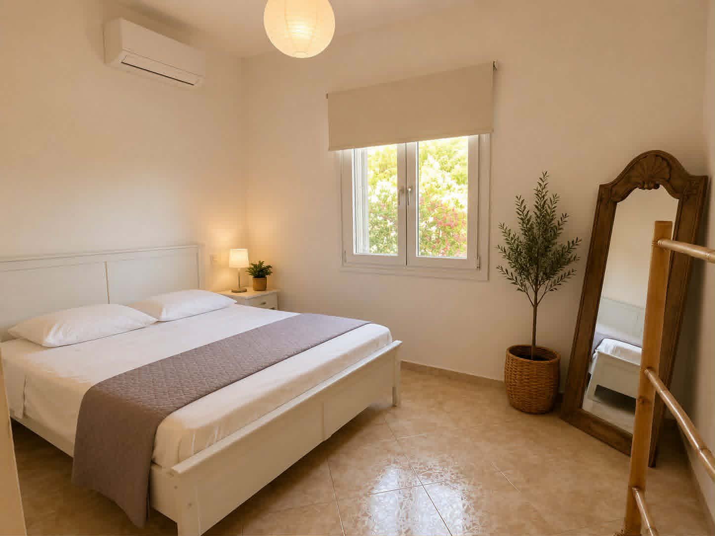Bedroom with double bed, nightstand & floor mirror