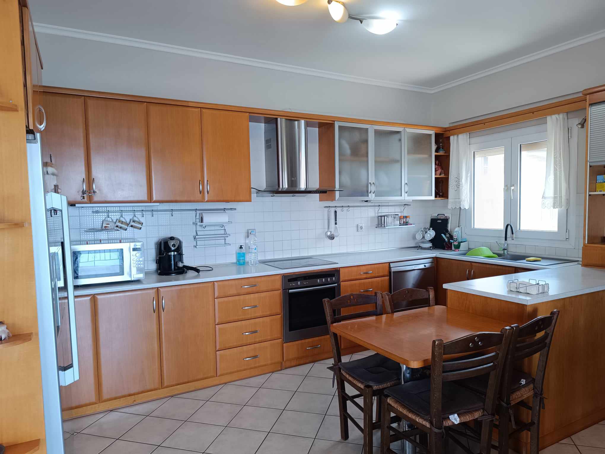 Kitchen with wood cabinetry & dining nook