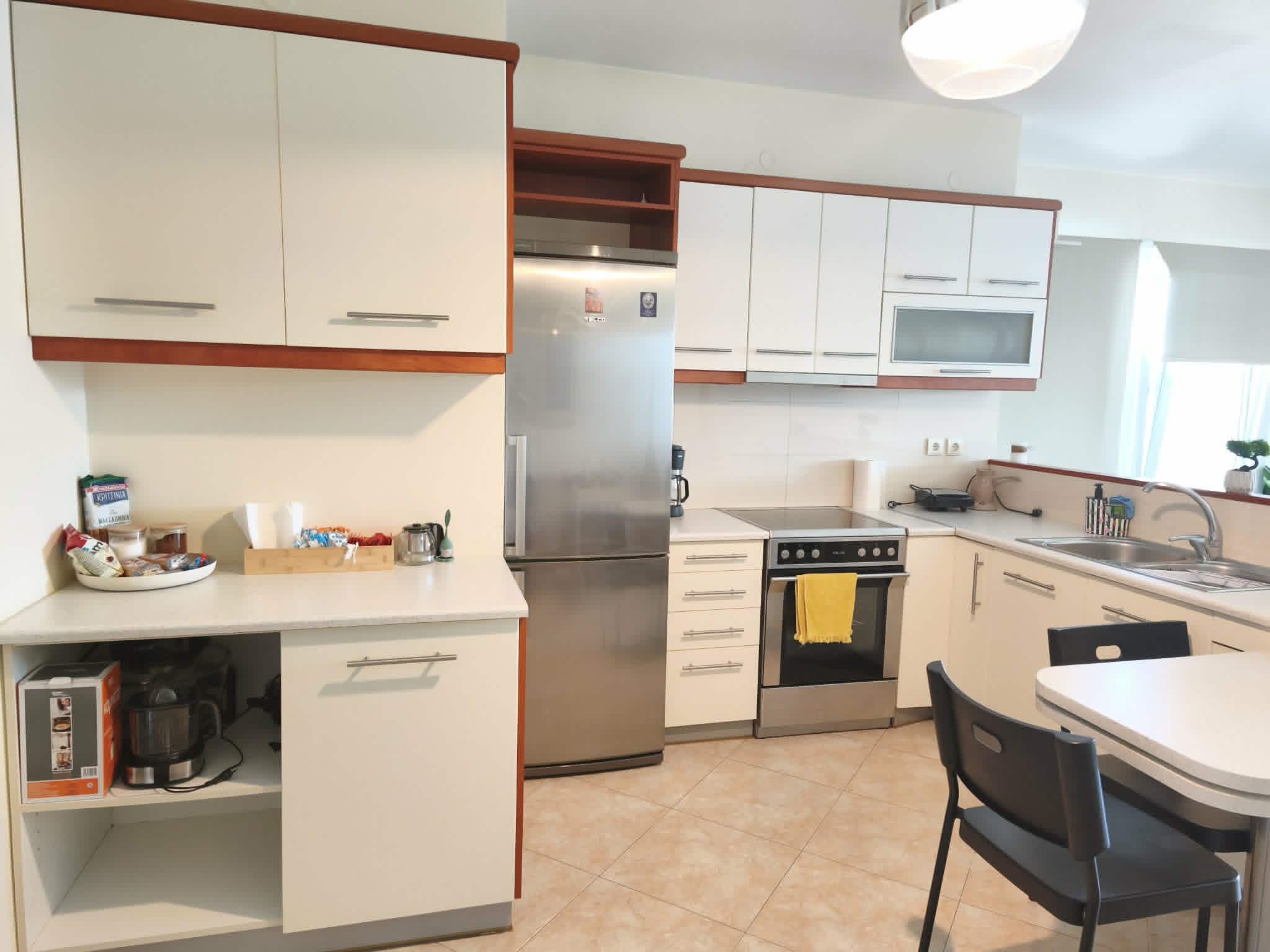 Kitchen with white cabinetry & dining nook