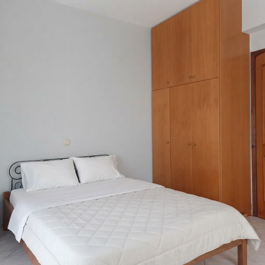 Bedroom with double bed, linens & built-in wardrobe
