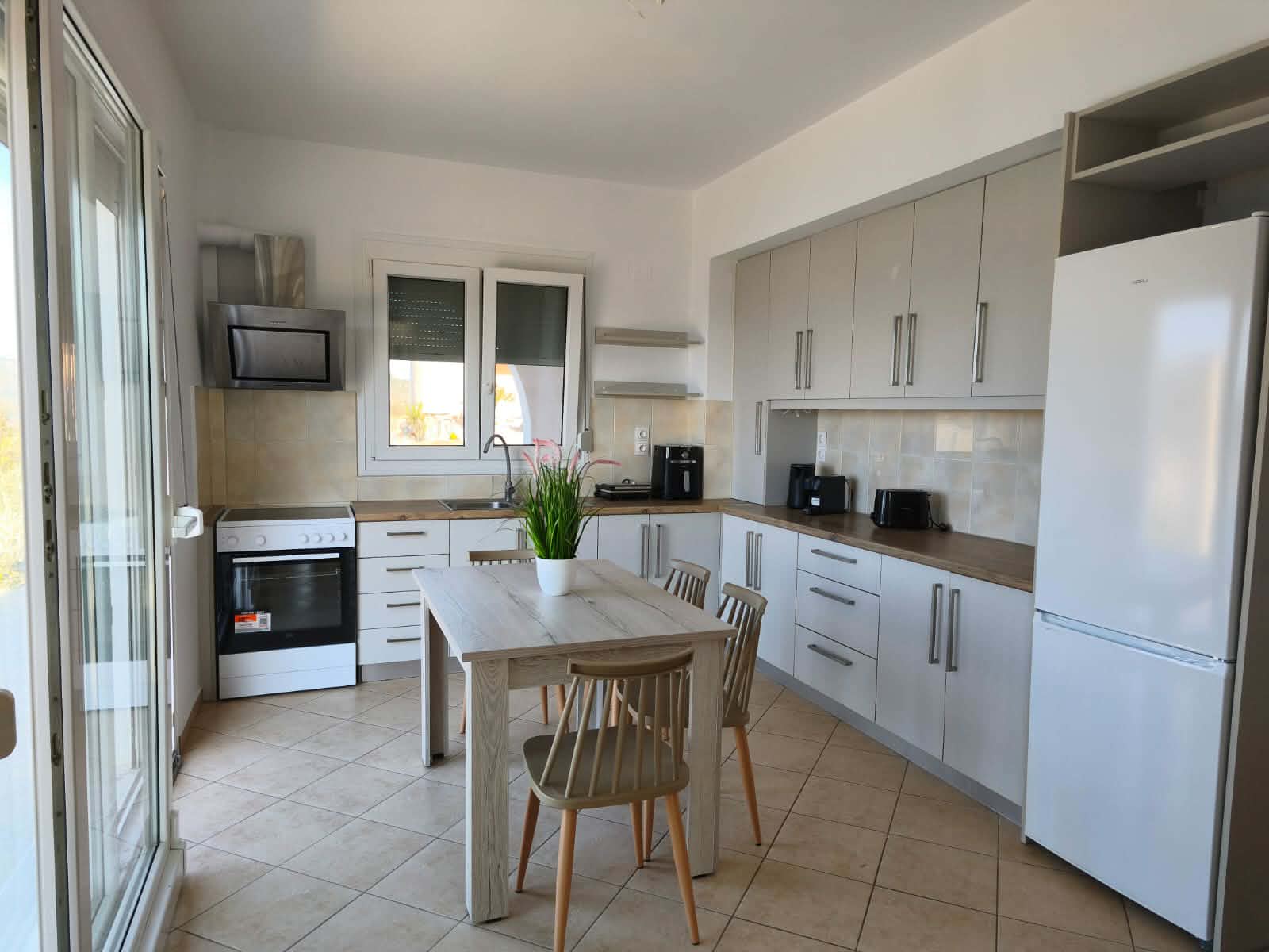 Kitchen with dining table, refrigerator & window