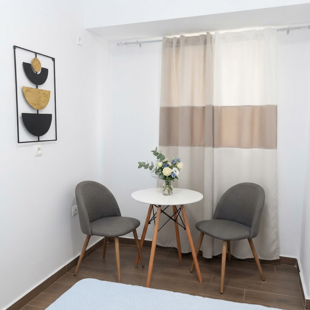 Bedroom corner with bistro table, chairs & flowers