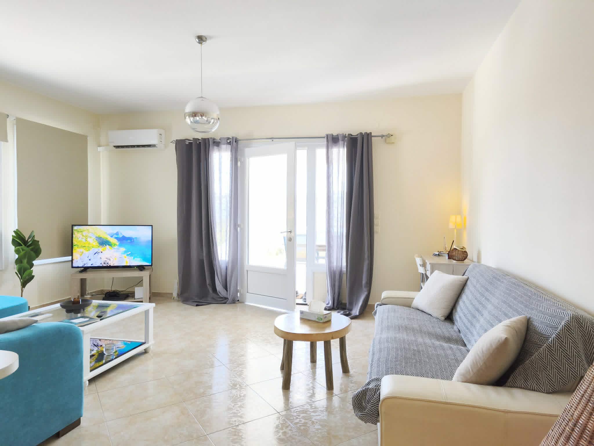 Living area with blue sofa & coffee tables