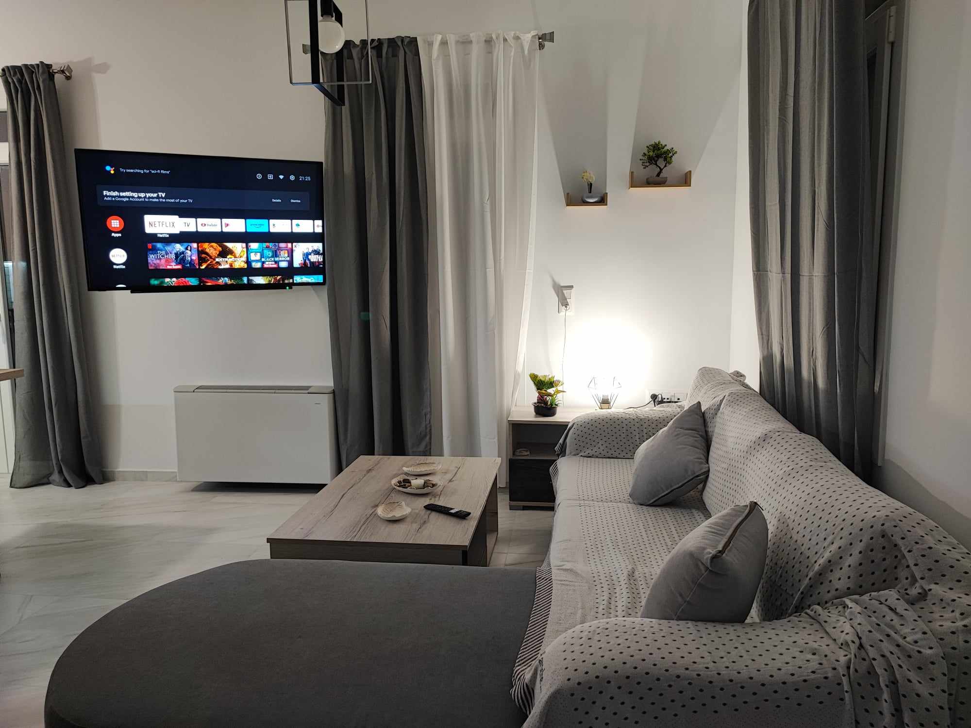 Living area with sectional sofa & wall-mounted TV