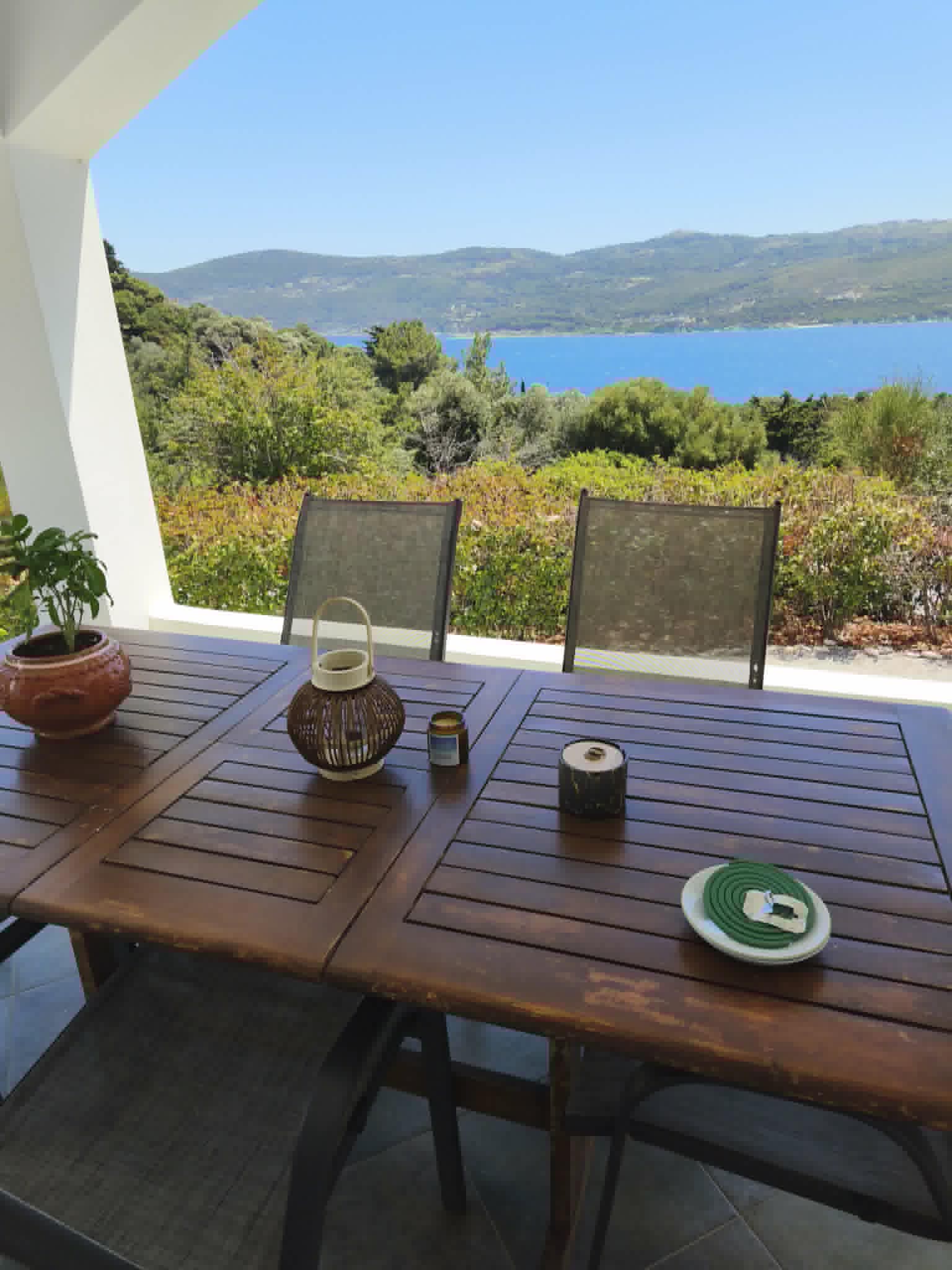 Covered terrace with basil plant & sea view