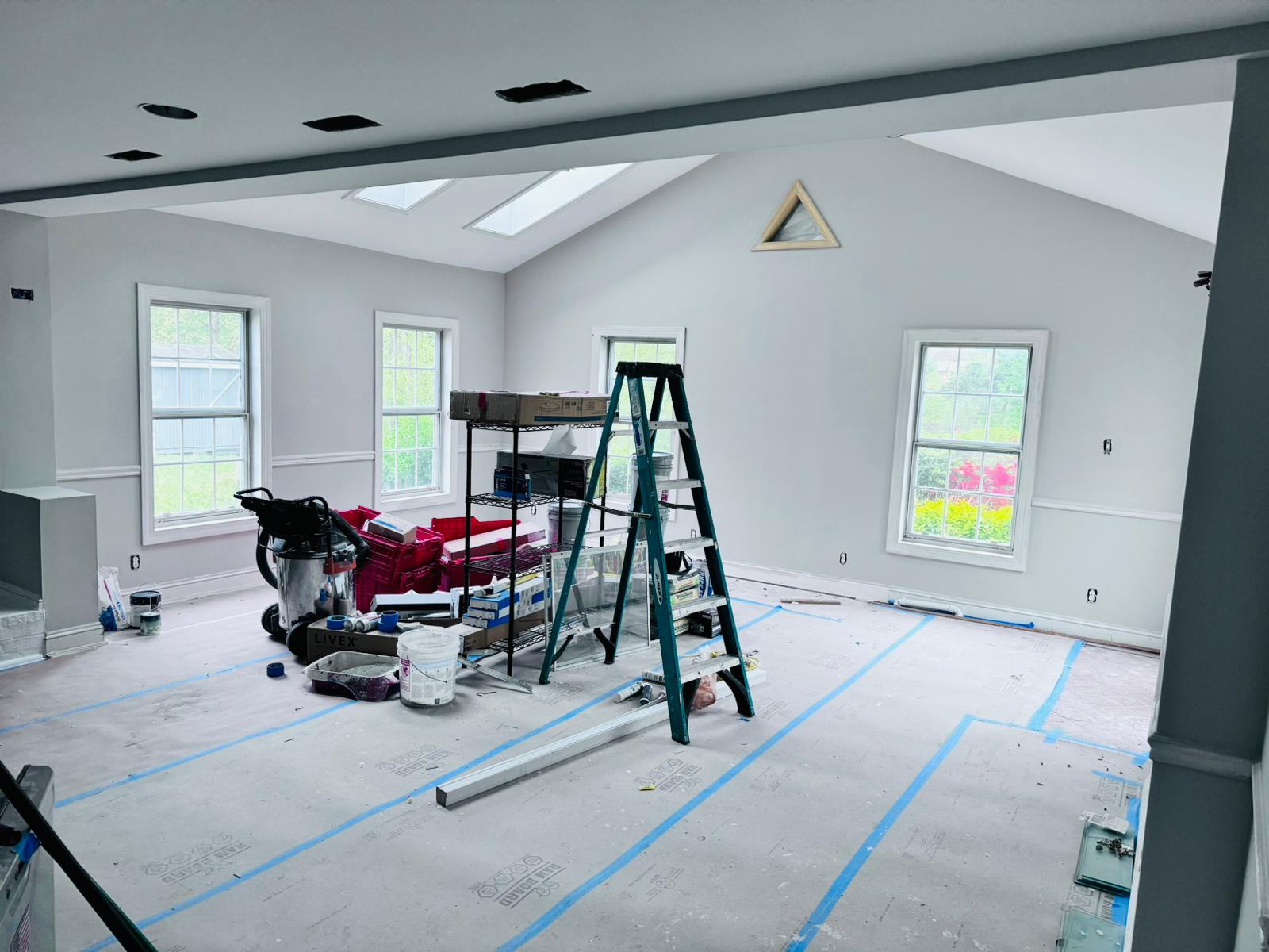 Vaulted room prepped with Ram Board floor protection during painting