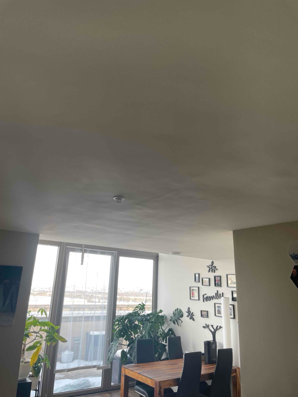 Restored dining area ceiling with fresh smooth finish