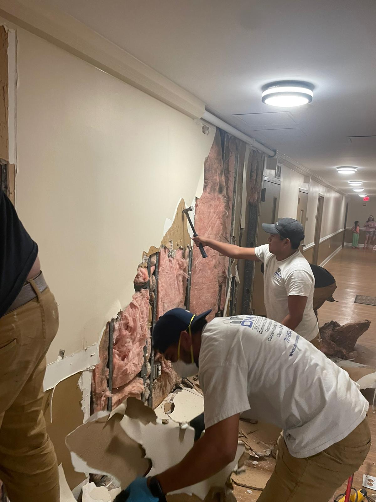 DMV Restoration crew performing hallway drywall demolition